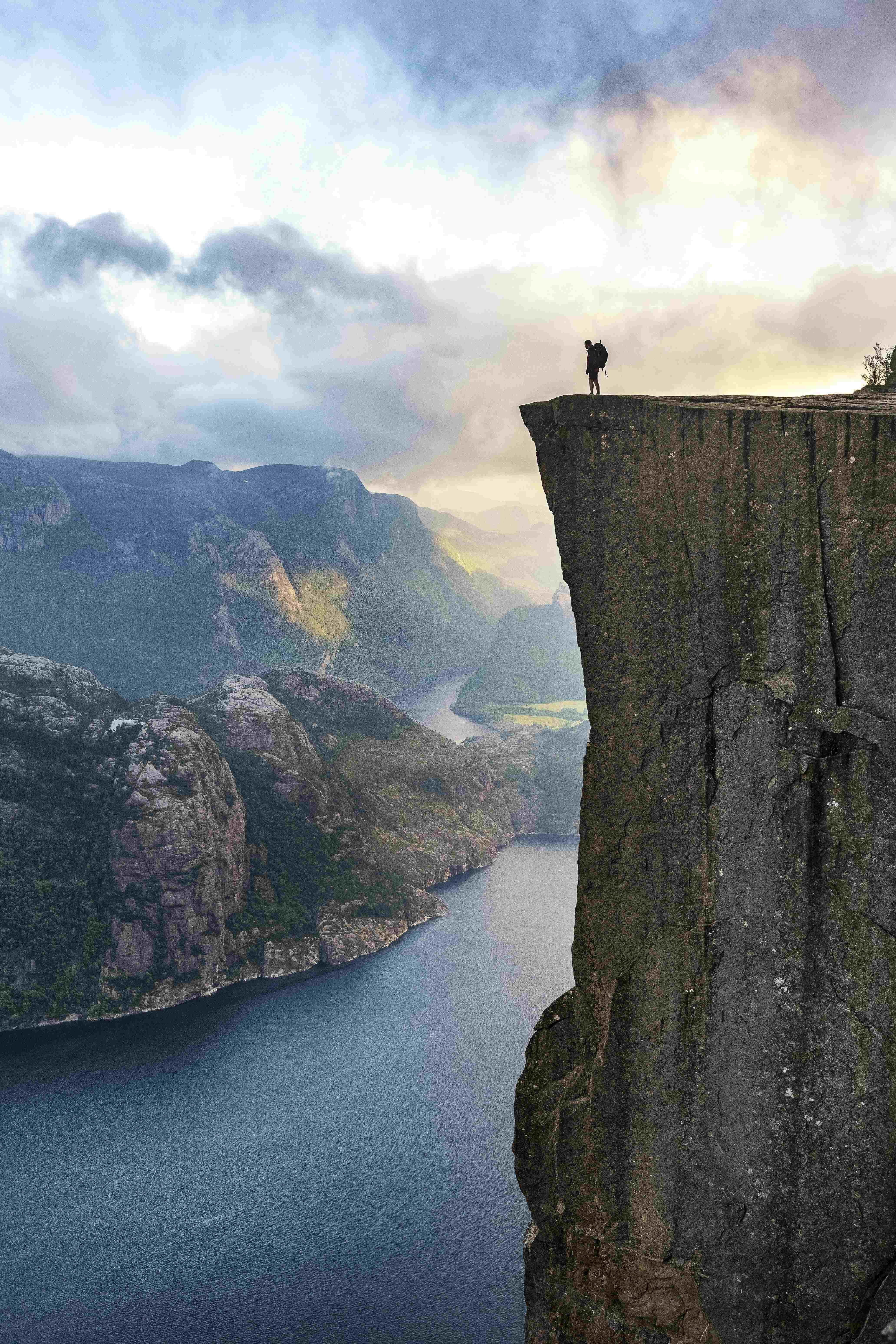 standing on Preikestolen Cliff in Norway