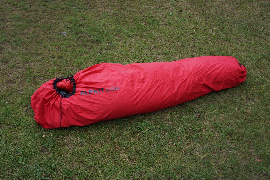 a bivvy bag laid out on the grass