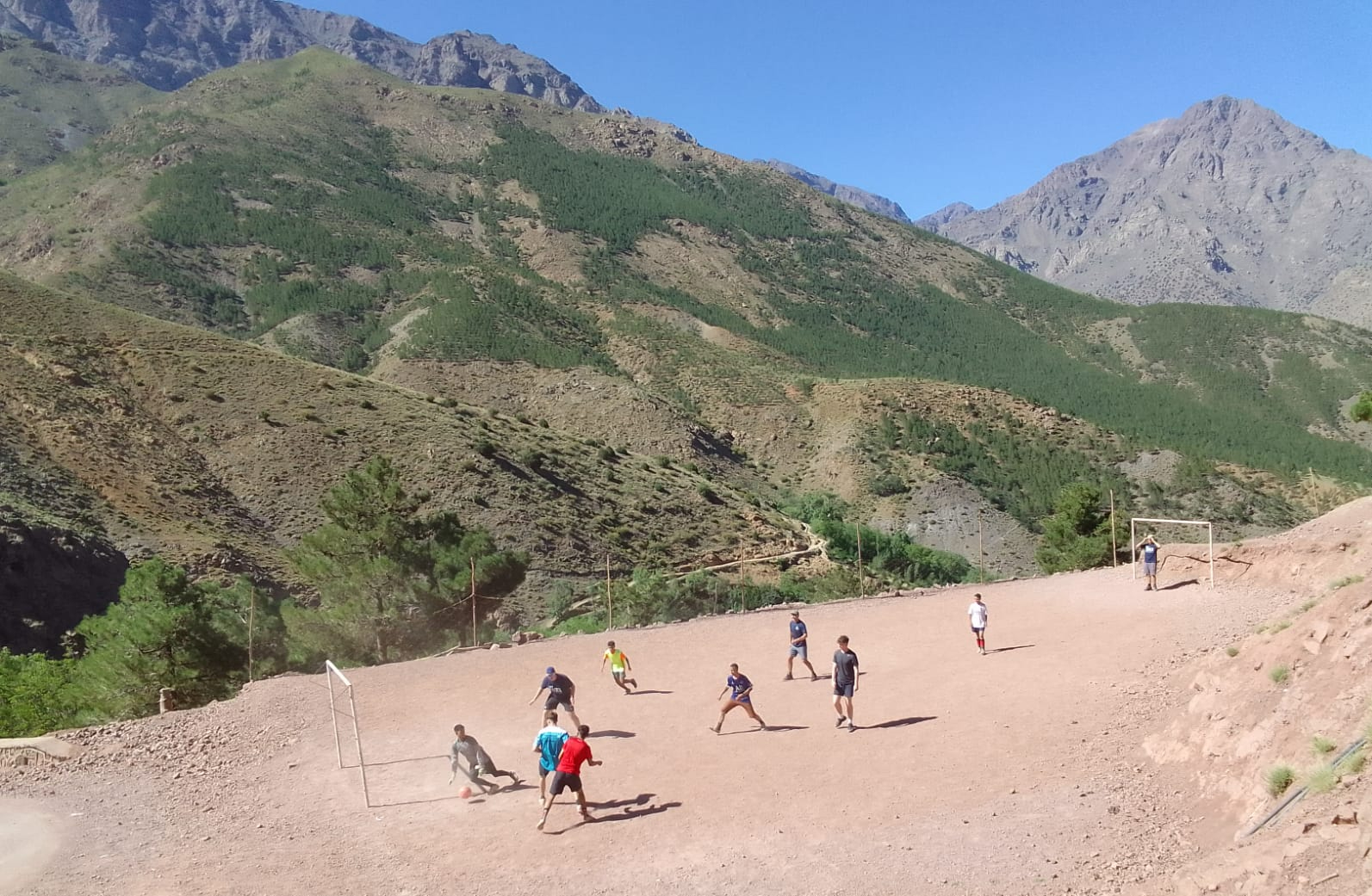 footballers playing on mountainside